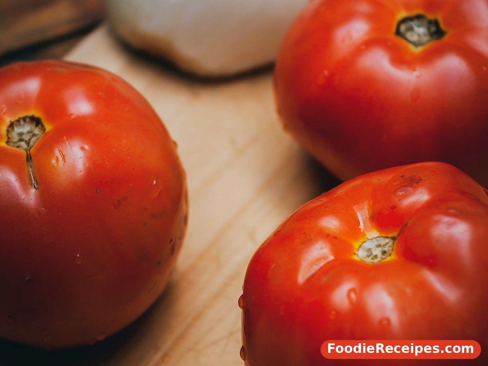 Ripe tomatoes and onion on a board